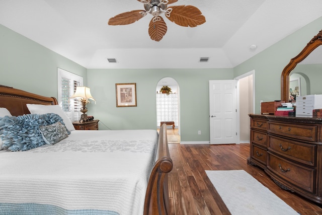 6568 Castlewood St, Navarre, FL 32566 - bedroom with dark wood-type flooring, ceiling fan, a tray ceiling, and vaulted ceiling