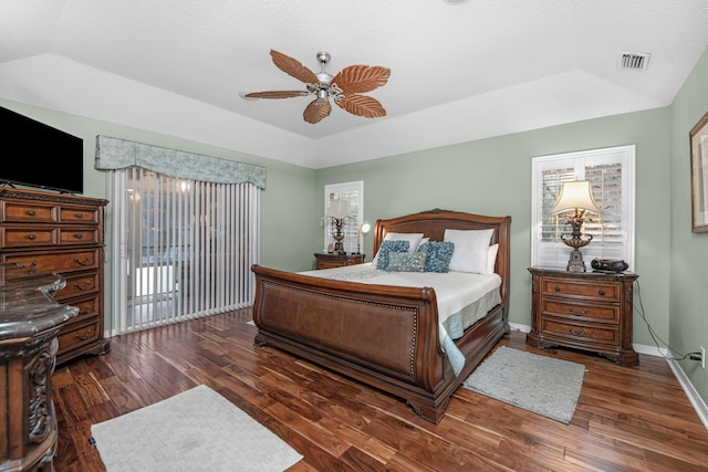 6568 Castlewood St, Navarre, FL 32566 - bedroom featuring vaulted ceiling, dark wood-type flooring, ceiling fan, and a tray ceiling