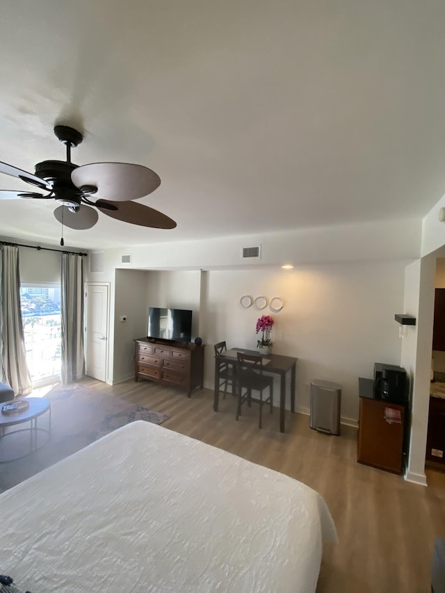 bedroom with ceiling fan and light hardwood / wood-style floors