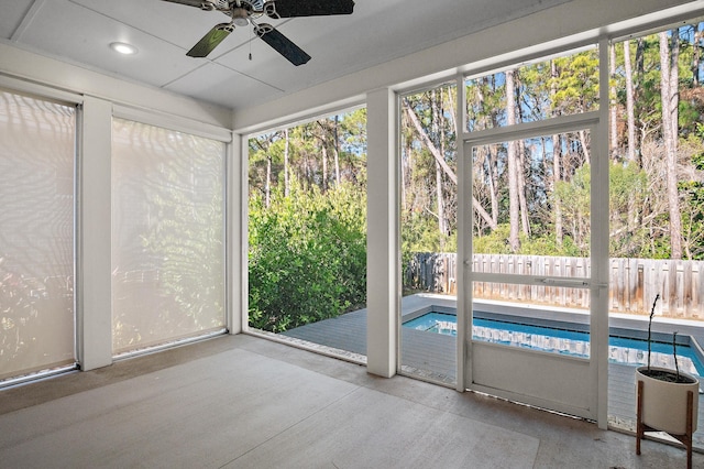 unfurnished sunroom with a wealth of natural light and ceiling fan