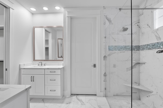 bathroom featuring vanity and a tile shower