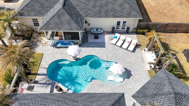 view of pool featuring an outdoor living space, a patio, and french doors