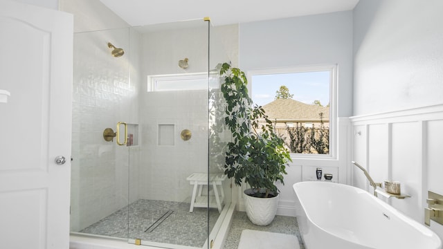 bathroom featuring shower with separate bathtub