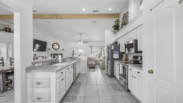 kitchen with sink, light tile patterned floors, ceiling fan, stainless steel appliances, and white cabinets