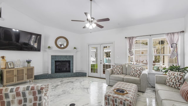 living room featuring a fireplace, french doors, and ceiling fan