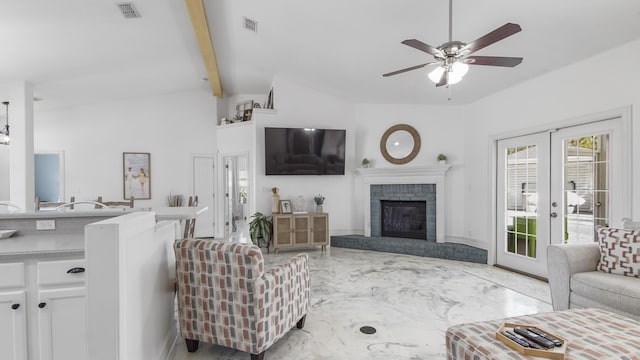 living room featuring french doors, ceiling fan, a fireplace, and vaulted ceiling with beams