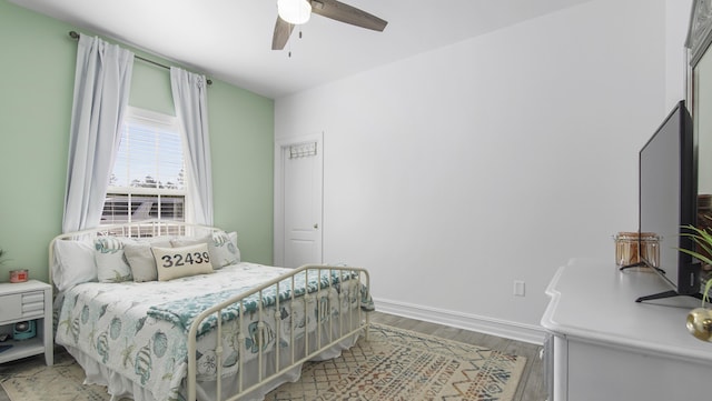 bedroom featuring hardwood / wood-style flooring and ceiling fan