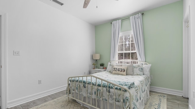 bedroom with hardwood / wood-style floors and ceiling fan