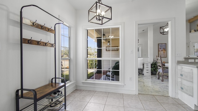 doorway featuring light tile patterned floors and a notable chandelier