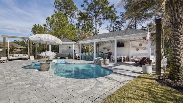 view of pool with pool water feature, outdoor lounge area, a jacuzzi, and a patio