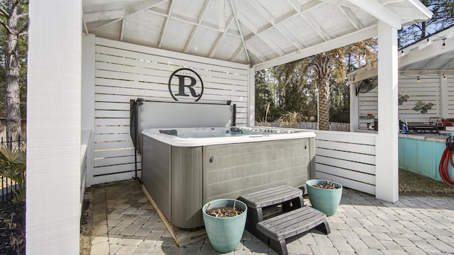 view of patio / terrace with a hot tub and a gazebo