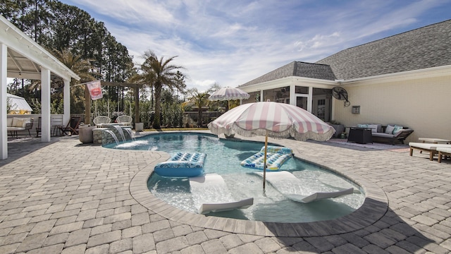 view of swimming pool featuring a patio, outdoor lounge area, and pool water feature