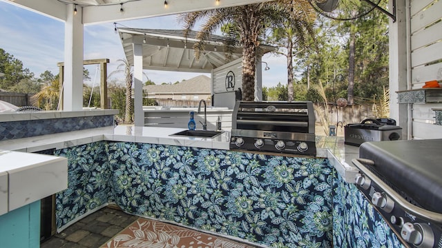 view of patio featuring a grill, area for grilling, and an outdoor wet bar