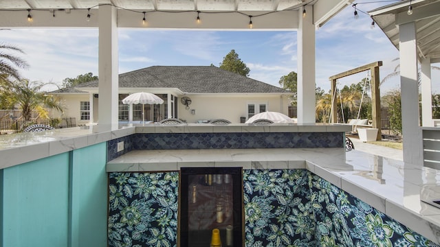 view of pool with exterior kitchen and an outdoor bar