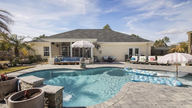 view of pool with a patio, outdoor lounge area, and french doors