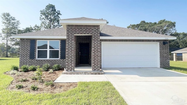 view of front of property with a garage and a front lawn