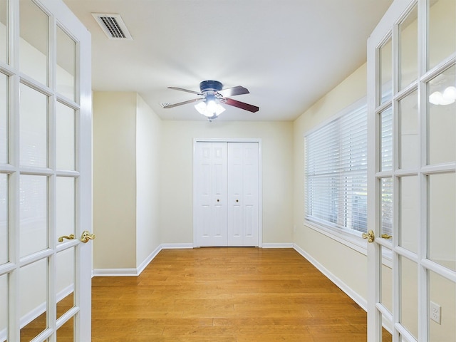 unfurnished bedroom with ceiling fan, visible vents, baseboards, a closet, and light wood-type flooring