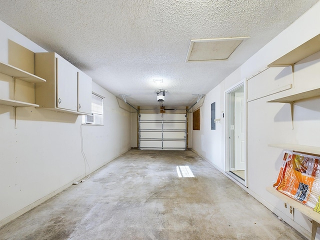 garage featuring electric panel and a garage door opener