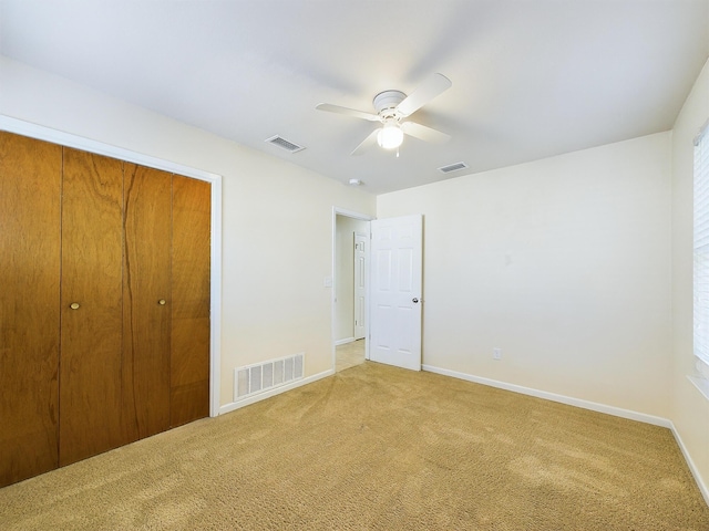 unfurnished bedroom featuring baseboards, a closet, visible vents, and carpet flooring