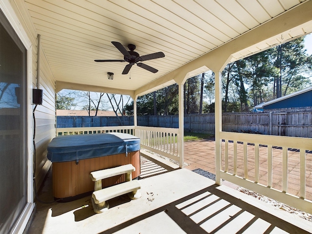 view of patio with a fenced backyard and a hot tub