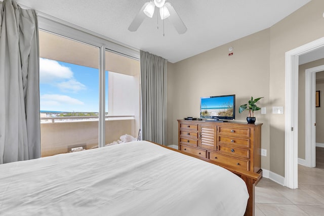 bedroom with ceiling fan, a textured ceiling, and light tile patterned floors