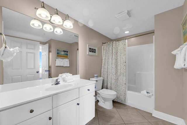 full bathroom featuring tile patterned flooring, vanity, shower / bath combination with curtain, a textured ceiling, and toilet