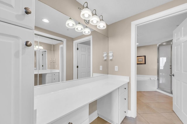 bathroom featuring tile patterned flooring, vanity, and walk in shower