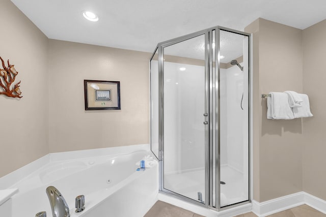 bathroom with tile patterned flooring and independent shower and bath