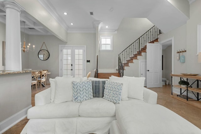 living room with ornate columns, a chandelier, ornamental molding, beam ceiling, and french doors