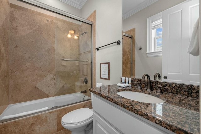 full bathroom featuring crown molding, enclosed tub / shower combo, vanity, and toilet