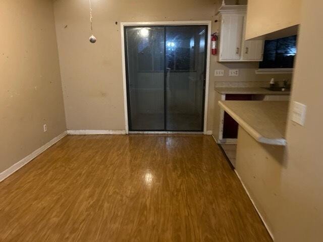 kitchen with hardwood / wood-style flooring and white cabinets