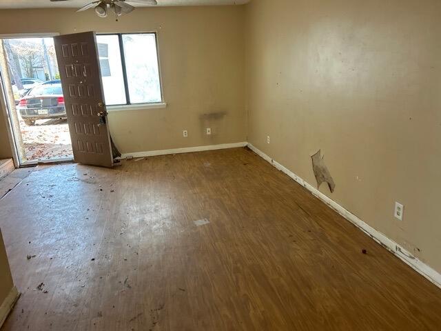 unfurnished room featuring hardwood / wood-style floors and ceiling fan