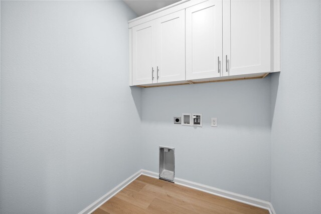 24 Riverwalk Cir, Freeport, FL 32439 - washroom with light wood-type flooring, baseboards, cabinet space, electric dryer hookup, and washer hookup