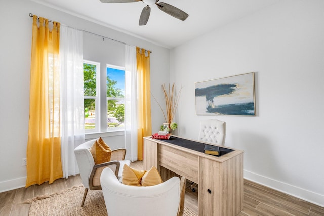 home office featuring dark wood-type flooring, a wealth of natural light, and ceiling fan