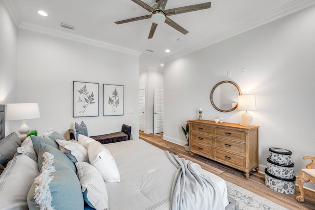 bedroom with crown molding, light hardwood / wood-style flooring, and ceiling fan