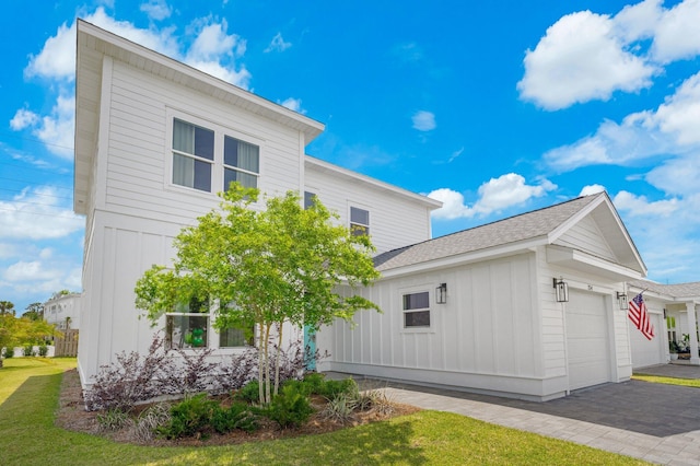 view of property exterior with a garage and a lawn