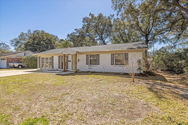 ranch-style home with a front lawn