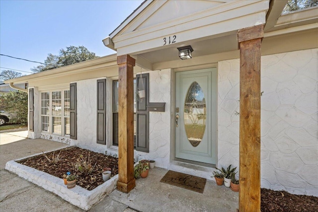 entrance to property with stucco siding