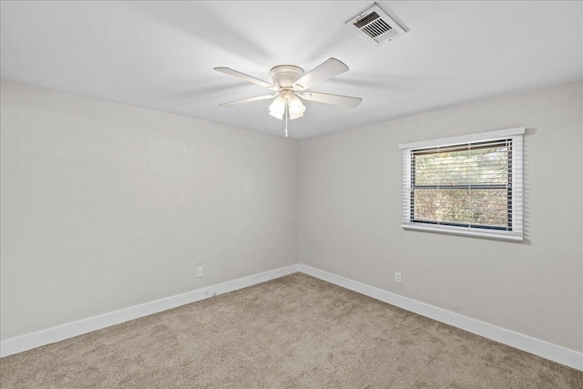 unfurnished room featuring carpet floors, baseboards, visible vents, and a ceiling fan