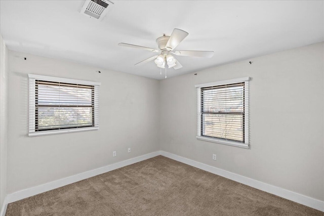 empty room with baseboards, visible vents, and a healthy amount of sunlight