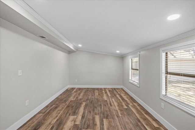 spare room featuring visible vents, crown molding, and baseboards