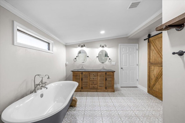 bathroom featuring a freestanding bath, visible vents, a sink, and ornamental molding