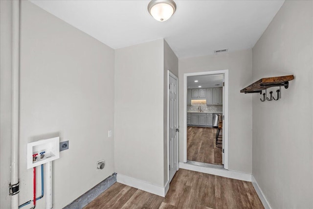 washroom with laundry area, visible vents, wood finished floors, hookup for a washing machine, and electric dryer hookup