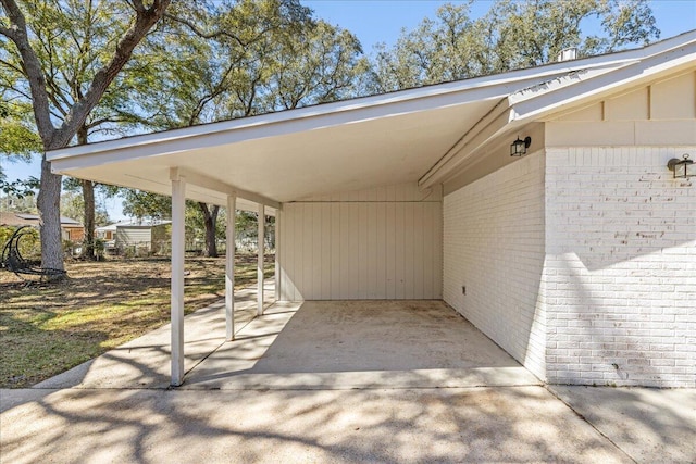 view of patio with concrete driveway and an attached carport