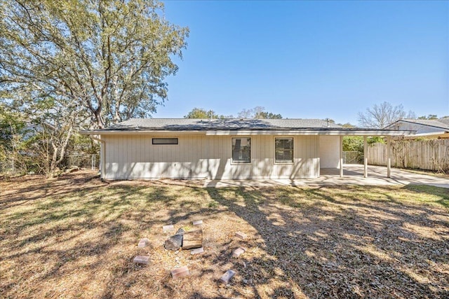 back of property with fence and a patio