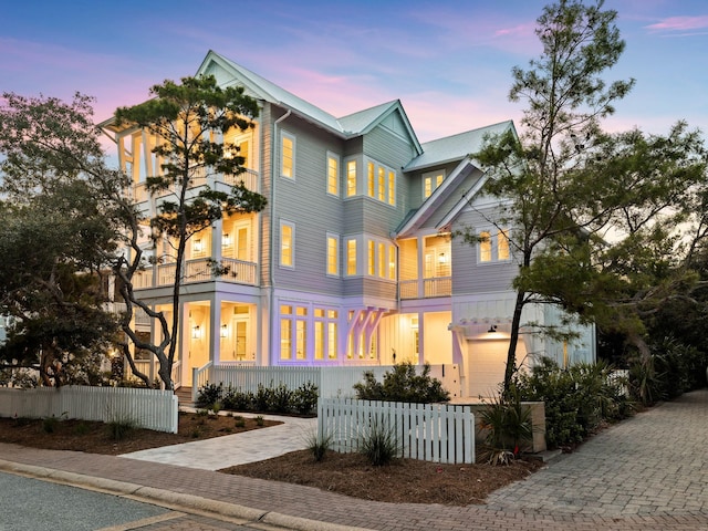 view of front facade featuring a balcony and a garage