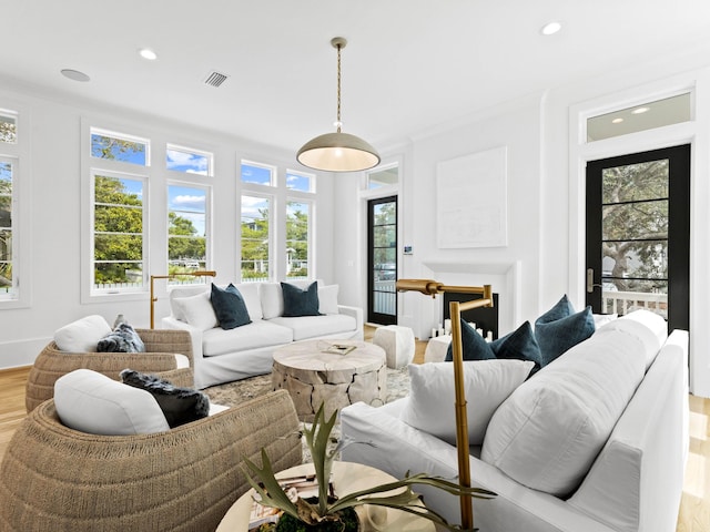 living room with hardwood / wood-style floors and ornamental molding