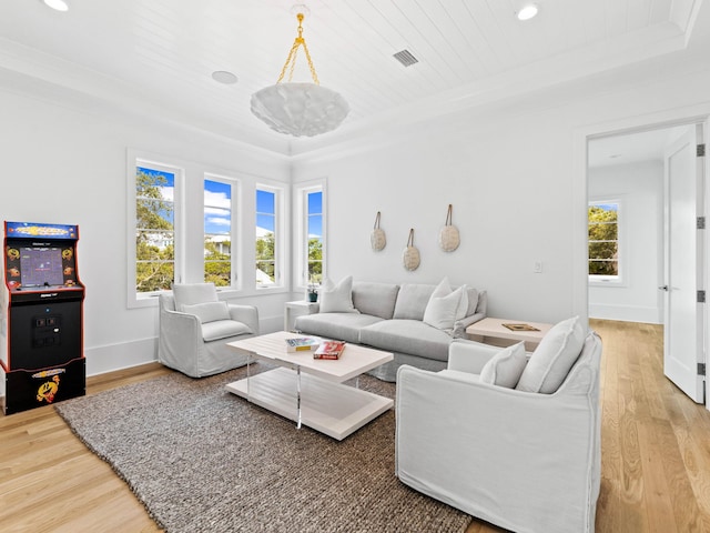 living room featuring hardwood / wood-style flooring, a raised ceiling, a notable chandelier, and wood ceiling