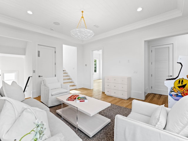 living room with wood-type flooring, wooden ceiling, and crown molding