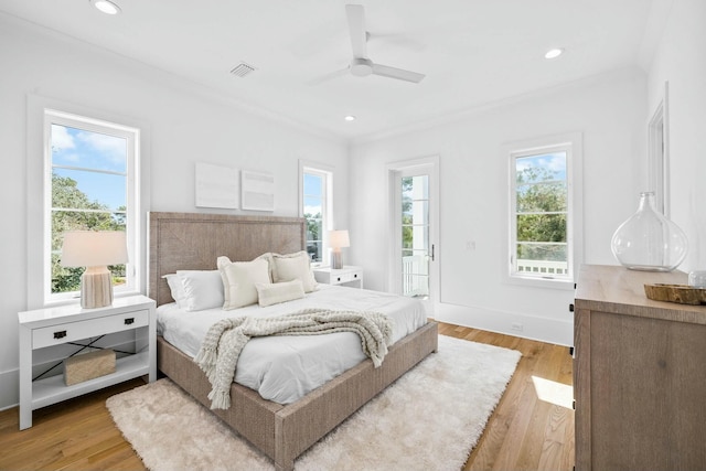 bedroom with ceiling fan, ornamental molding, and light hardwood / wood-style flooring